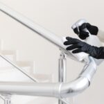 hands with gloves disinfecting hand rail. High quality beautiful photo concept
